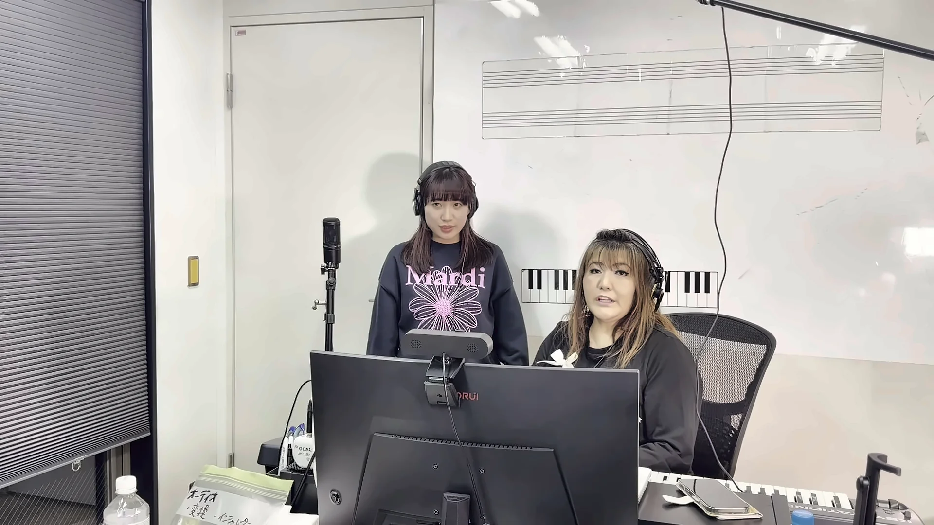 Vocal Campのレッスン風景：生徒がマイク前で歌い、講師がモニター越しに声を分析する